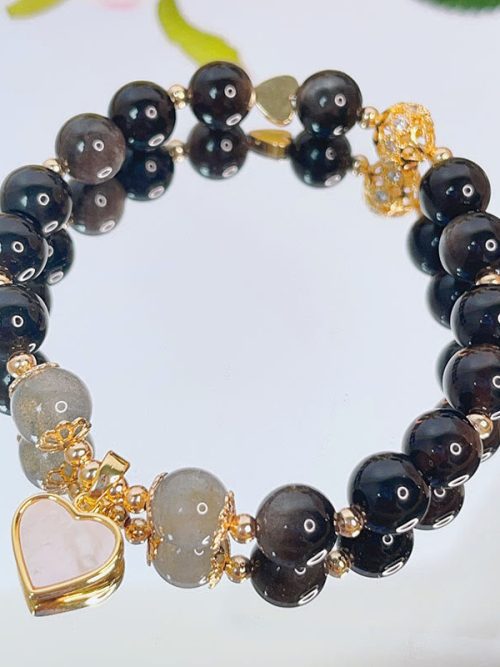 Obsidian Zodiac Buddha Bracelet is a powerful spiritual piece designed to provide protection, grounding, and energy alignment based on your zodiac sign. Combining black obsidian with a symbolic Buddha charm, it represents strength, balance, and personal guidance. Obsidian is known for its grounding and protective properties. It is often used to shield against negative energy and promote emotional stability. Wearing an Obsidian Zodiac Buddha Bracelet helps create a sense of security and inner strength. The red agate accent enhances vitality and confidence, while the zodiac Buddha symbolizes a personal guardian connected to your birth sign. This makes the Obsidian Zodiac Buddha Bracelet deeply meaningful for those seeking spiritual support and life balance. ✨ Energy & Meaning Provides strong protection and grounding Aligns energy with your zodiac guardian Enhances confidence and emotional stability Supports spiritual awareness and balance 📿 Material Composition Natural black obsidian beads Red agate (Nanhong-style accent bead) Zodiac Buddha charm Elastic cord for comfortable wear 🌿 Usage Scenarios Daily wear for protection and grounding Spiritual and mindfulness practices Personal energy alignment based on zodiac Meaningful gift for protection and guidance Want a bracelet tailored to your exact birth energy? Explore our BaZi Custom Crystal Service and create your own Obsidian Zodiac Buddha Bracelet. Discover more in our Protection & Balance Collection. 💫 Why You'll Love It The Obsidian Zodiac Buddha Bracelet combines powerful symbolism with protective energy. It is perfect for those who want guidance, strength, and balance in everyday life. ⚠️ Tips Avoid impact to protect stone surface Keep away from chemicals Clean gently with a soft cloth